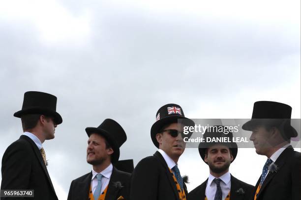 Racegoers attend the second day of the Epsom Derby Festival in Surrey, southern England on June 2, 2018.