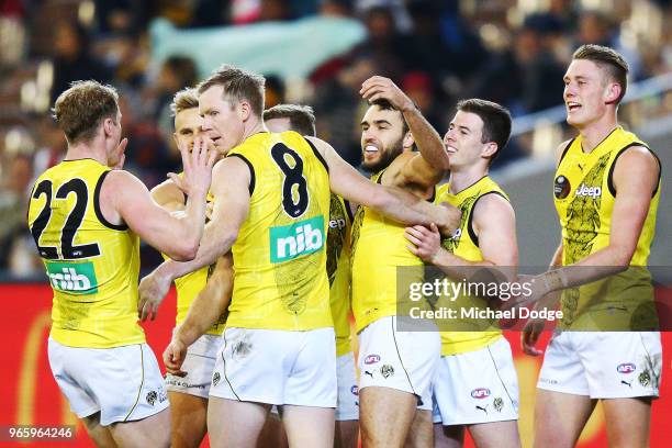 Shane Edwards of the Tigers celebrates a goal with teammates during the round 11 AFL match between the Essendon Bombers and the Richmond Tigers at...