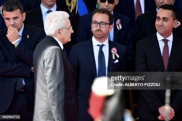 Italy's President Sergio Mattarella arrives while walking past Italy's Agriculture Minister Gian Marco Centinaio , Italy's Justice Minister Alfonso...