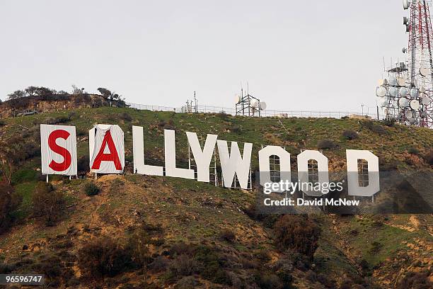 Activists begin covering up the iconic 450-foot-long Hollywood sign during an effort to prevent the building of houses there on February 11, 2010 in...