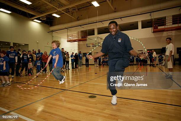 Avery Johnson of ESPN and some kids excercise at the NBA Fit All-Star Youth Celebration at the T.Boone Pickens YMCA on February 11, 2010 in Dallas,...