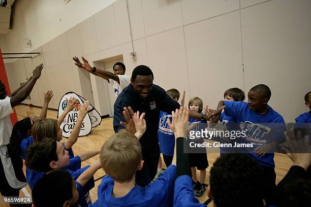 Avery Johnson high fives kids excercise at the NBA Fit All-Star Youth Celebration at the T.Boone Pickens YMCA on February 11, 2010 in Dallas, Texas....
