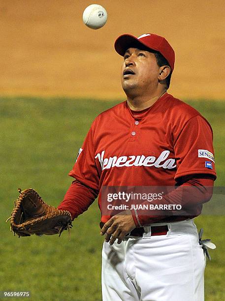 Venezuelan President Hugo Chavez tosses a ball in the air before a softball match with professional Venezuelan players in Caracas on February 11,...