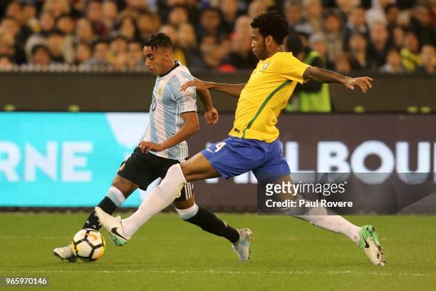 Jose Luis Gomez of Argentina competes for the ball with Willian of Brazil during the Brazil Global Tour match between Brazil and Argentina at...
