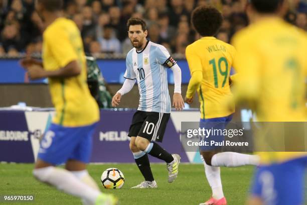 Lionel Messi of Argentina runs with the ball during the Brazil Global Tour match between Brazil and Argentina at Melbourne Cricket Ground on June 9,...