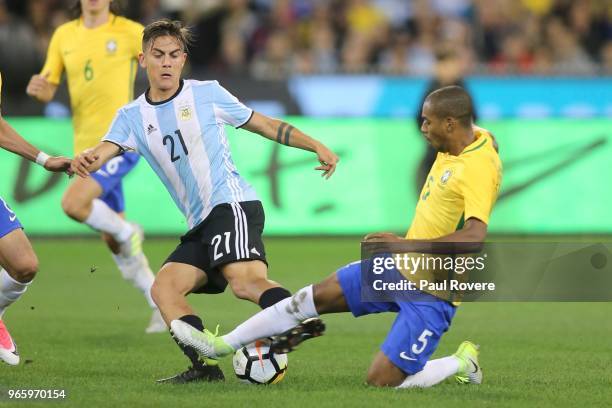 Paulo Dybala of Argentina competes for the ball with Fernandinho of Brazil during the Brazil Global Tour match between Brazil and Argentina at...