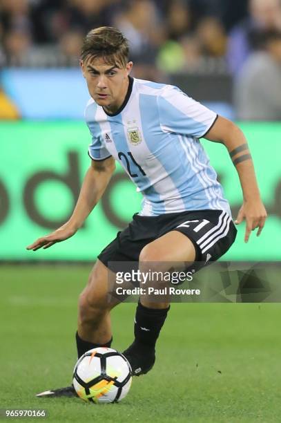Paulo Dybala of Argentina runs with the ball during the Brazil Global Tour match between Brazil and Argentina at Melbourne Cricket Ground on June 9,...