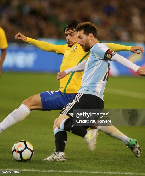 Lionel Messi of Argentina leads Fagner of Brazil to the ball during the Brazil Global Tour match between Brazil and Argentina at Melbourne Cricket...