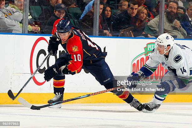David Booth of the Florida Panthers battles for the puck against Alexandre Burrows of the Vancouver Canucks at the BankAtlantic Center on February...