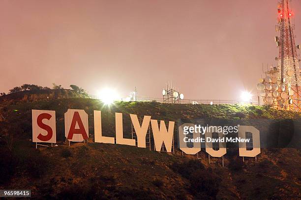 Activists stop for the night after beginning to cover up the iconic 450-foot-long Hollywood sign during an effort to prevent the building of houses...