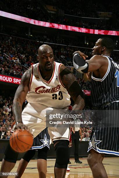 Shaquille O'Neal of the Cleveland Cavaliers pushes into the paint against Dwight Howard of the Orlando Magic on February 11, 2010 at The Quicken...