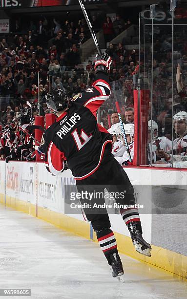 Chris Phillips of the Ottawa Senators raises his stick to celebrate his third period goal against the Washington Capitals at Scotiabank Place on...