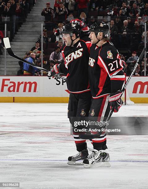 Chris Phillips of the Ottawa Senators celebrates his third period goal against the Washington Capitals with teammate Alexei Kovalev at Scotiabank...