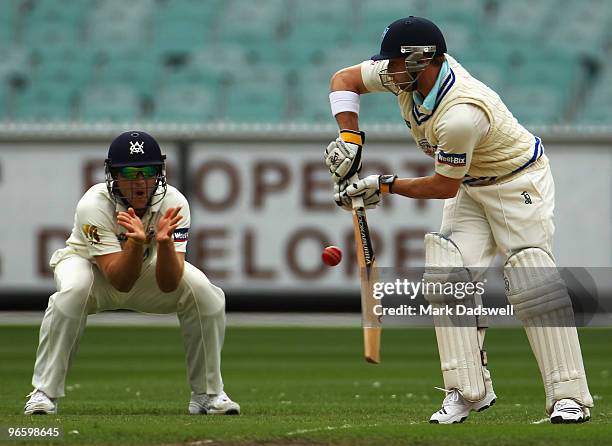 Phillip Hughes of the Blues plays forward defensively during day one of the Sheffield Shield match between the Victorian Bushrangers and the New...