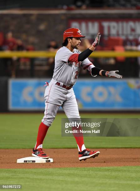 Alex Blandino of the Cincinnati Reds gestures to his dugout after hitting a lead off double during the first inning of a game against the Arizona...