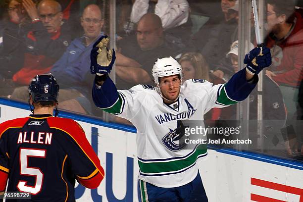 Ryan Kesler of the Vancouver Canucks raises his stick to celebrate after scoring a goal against the Florida Panthers on February 11, 2010 at the...