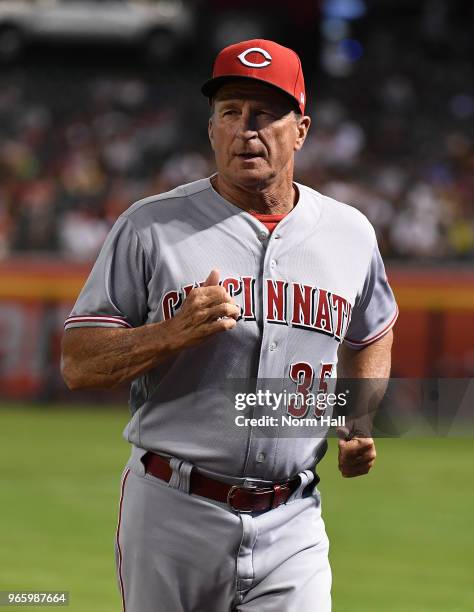 Manager Jim Riggleman of the Cincinnati Reds walks back to the dugout after making a pitchers mound visit against the Arizona Diamondbacks at Chase...