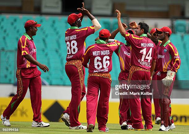 Ravi Rampaul of the West Indies is congratulated by his team mates after taking the wicket of Tim Paine of Australia during the Third One Day...