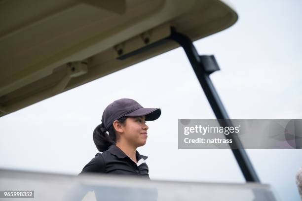 focused asian female golfer - tee box stock pictures, royalty-free photos & images