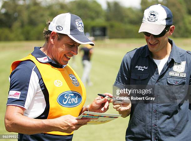 Geelong Coach Mark Thompson signs an autograph for a fan during a Geelong Cats intra-club AFL match at Gipps Road Park on February 12, 2010 in...