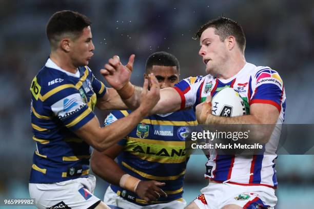 Lachlan Fitzgibbon of the Knights is tackled by Mitchell Moses of the Eels during the round 13 NRL match between the Parramatta Eels and the...