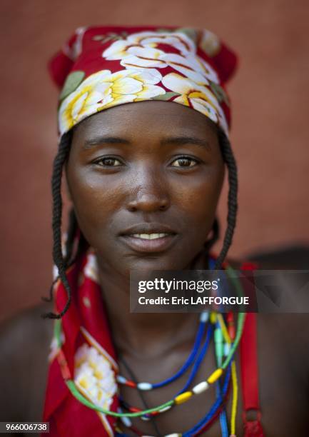 Woman who is a refugee from Angolan Civil War. They surviving by begging and posing topless for tourists in front of supermarkets.