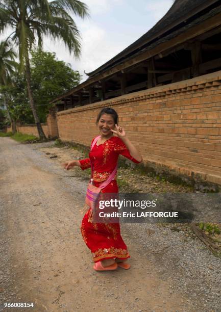 Dai woman making v sign, galamba, xishuangbanna region, yunnan province, China on May 31, 2007 in Menglun, China.