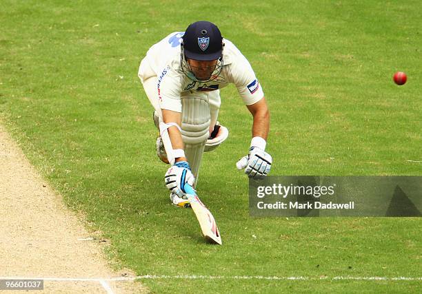 Phil Jaques of the Blues dives to make the crease as the ball is thrown at the stumps during day one of the Sheffield Shield match between the...