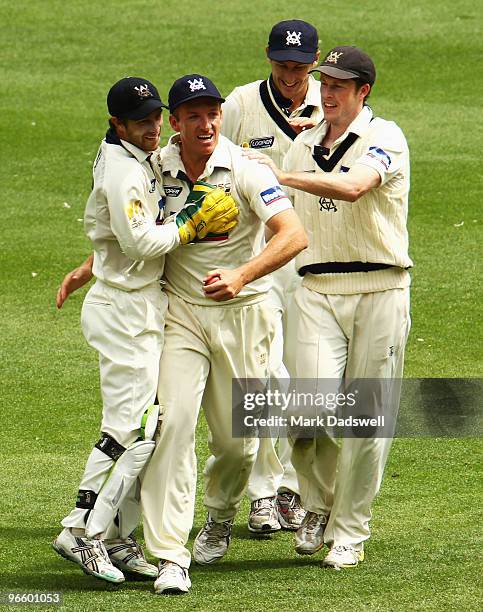 Damien Wright of the Bushrangers celebrates holding a catch to dismiss Phil Jaques of the Blues off the bowling of Darren Pattinson during day one of...