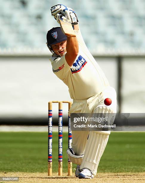 Peter Forrest of the Blues plays a straight drive during day one of the Sheffield Shield match between the Victorian Bushrangers and the New South...
