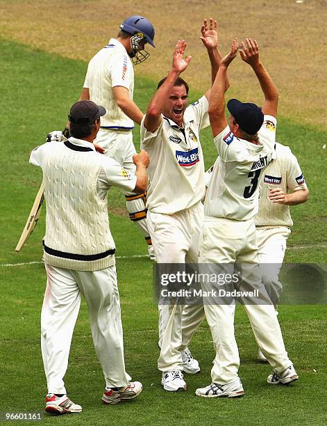 Steven Smith of the Blues leaves the ground as John Hastings of the Bushrangers is congratulated by teammates during day one of the Sheffield Shield...
