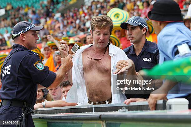 Spectator is removed from the ground by police during the Third One Day International match between Australia and the West Indies at Sydney Cricket...