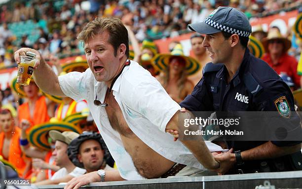 Spectator is removed from the ground by police during the Third One Day International match between Australia and the West Indies at Sydney Cricket...