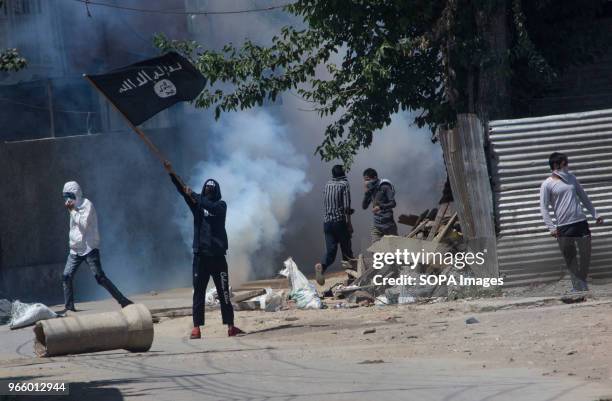 Kashmiri Muslim protestor waves ISIS flag during a funeral procession of a Kashmiri civilian Kaiser Amin Bhat in Sinagar, the summer capital of...