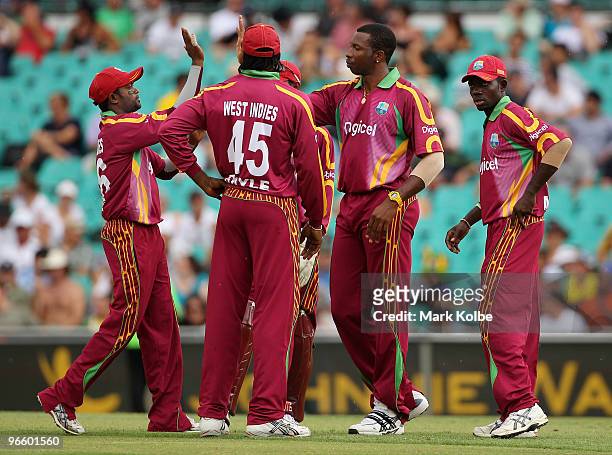 Kieron Pollard of the West Indies celebrates with his team after taking the wicket of Cameron White of Australia during the Third One Day...
