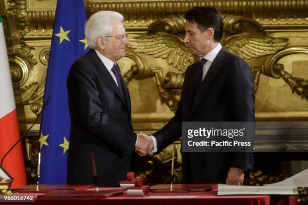 Italian President Sergio Mattarella shakes hands with Premier Giuseppe Conte during the swearing in ceremony of the new Italian government at the...