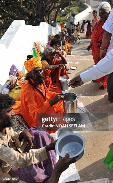 Beggars wait for alms on the occasion of Maha Shivaratri, the great night of Shiva outside the Keesara Gutta Temple on the outskirts of Hyderabad on...