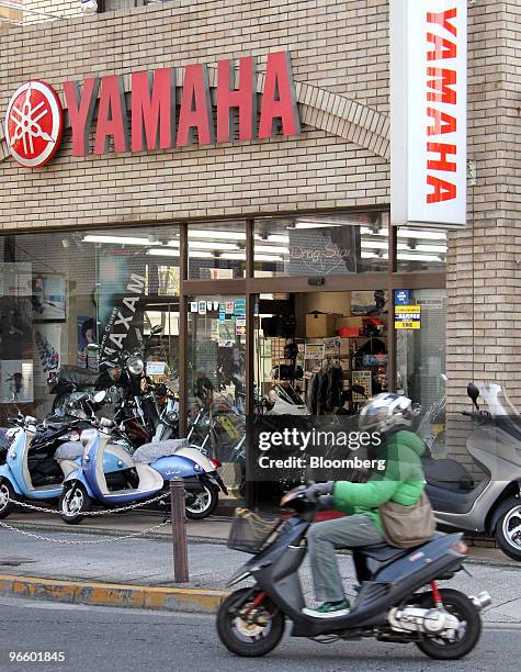 Motorist rides a scooter past a Yamaha Motor Co. Dealer, in Tokyo, Japan, on Wednesday, Feb. 10, 2010. Yamaha Motor Co., the world's second-largest...