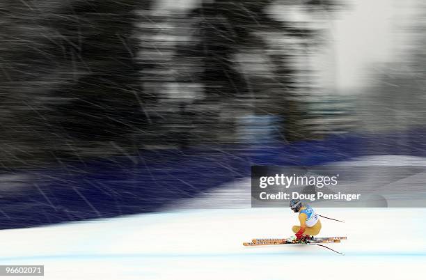 Michael Janyk of Canada descends as weather moves in and snow begins to fall as he is the last competitor to ski the course on the downhill course...