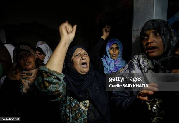 Relatives mourn over the deeath of 21 years old Razan al-Najjar during her funeral after she was shot dead by Israeli soldiers, in Khan Yunis on June...