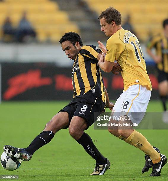 Paul Ifill of the Phoenix is tackled by Alex Wilkinson captain of the Mariners during the round 27 A-League match between the Wellington Phoenix and...