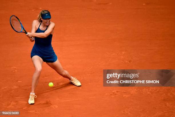 Russia's Maria Sharapova returns the ball to Czech Republic's Karolina Pliskova during their women's singles third round match on day seven of The...