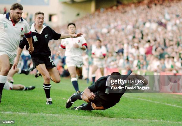Jonah Lomu of New Zealand dives over for the try during the 1995 Rugby World Cup match between England and New Zealand played in Cape Town, South...