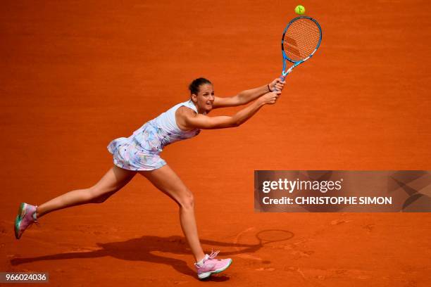 Czech Republic's Karolina Pliskova returns the ball to Russia's Maria Sharapova during their women's singles third round match on day seven of The...