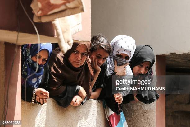 Palestinian people attend the funeral of 21 years old Razan al-Najjar after she was shot dead by Israeli soldiers, in Khan Yunis on June 2, 2018. A...