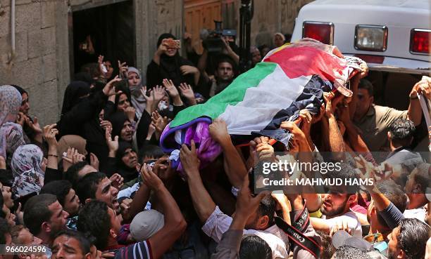Palestinian mourners carry the body of 21 years old Razan al-Najjar during her funeral after she was shot dead by Israeli soldiers, in Khan Yunis on...