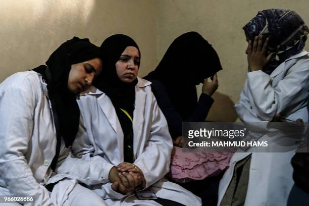 Colleagues mourn over the death of 21 years old Razan al-Najjar during her funeral after she was shot dead by Israeli soldiers, in Khan Yunis on June...