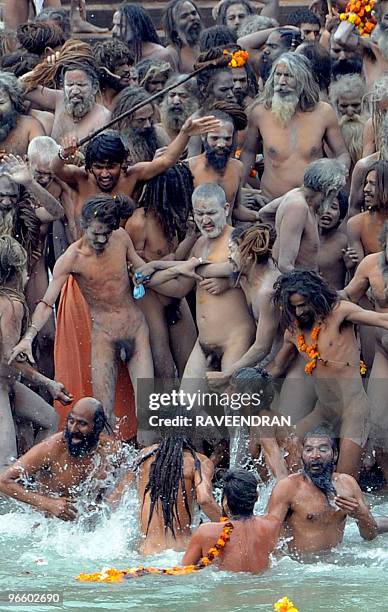 Indian Naga Sadhus - Holy Men - bathe at Har-ki-Pauri at the Ganga River during the First Shahi Snan - Royal Bath - on Maha Shivratri during the...