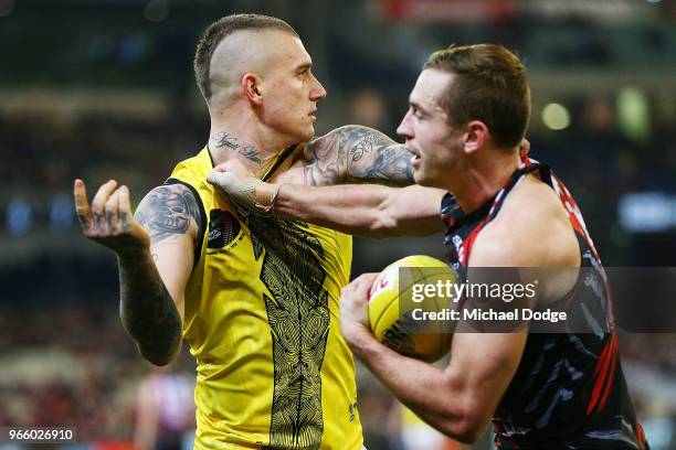 Dustin Martin of the Tigers and Devon Smith of Essendon wrestle during the round 11 AFL match between the Essendon Bombers and the Richmond Tigers at...