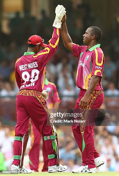 Dwayne Smith of the West Indies celebrates the wicket of Michael Hussey of Australia during the Third One Day International match between Australia...